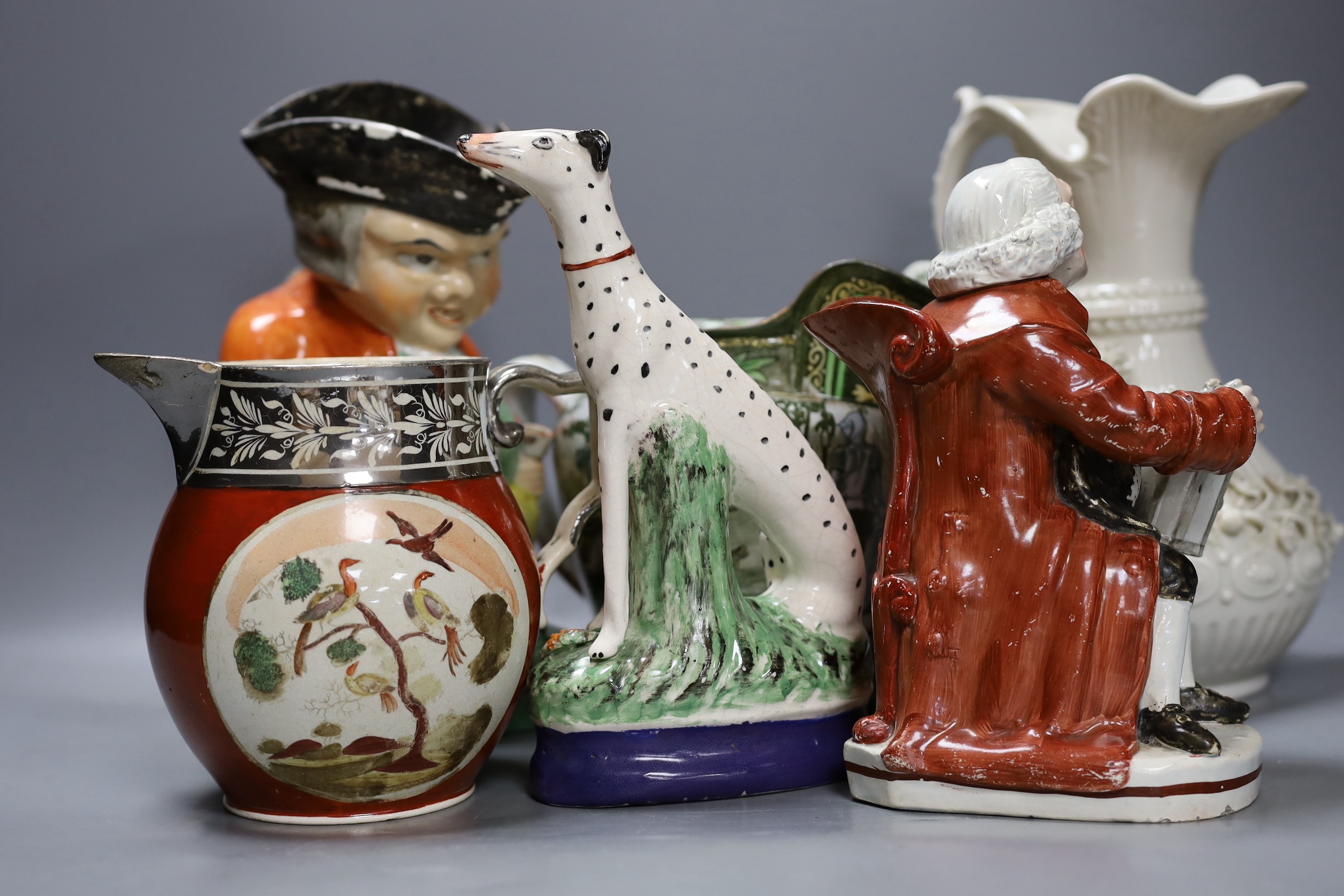 An early 19th century Staffordshire pearlware Night Watchman character jug, a Belleek ewer, a Staffordshire figure of a Dalmatian dog, a Royal Doulton jug and two other items, tallest 23cm (6)